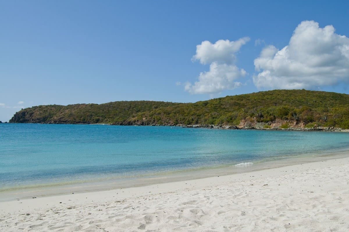 One of the breathtaking St John beaches boasts pristine white sand and crystal-clear blue water.