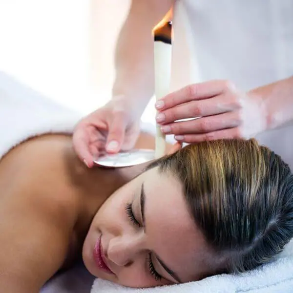 A woman enjoying a relaxing back massage at a luxurious spa during her vacation.